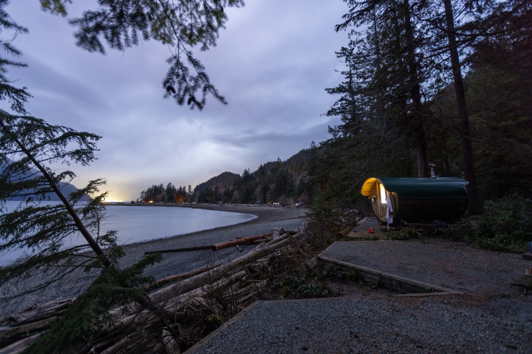 The wood-fired barrel sauna glowing at dusk